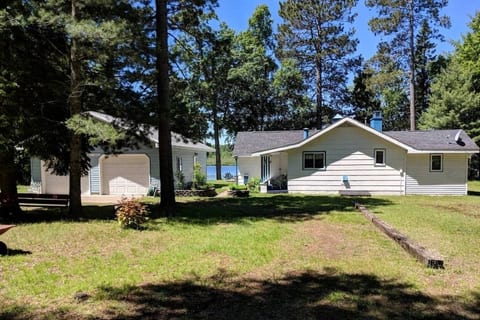 Embrace nature’s beauty with lake views and charming, spacious grounds! Front of cottage facing Evergreen Dr