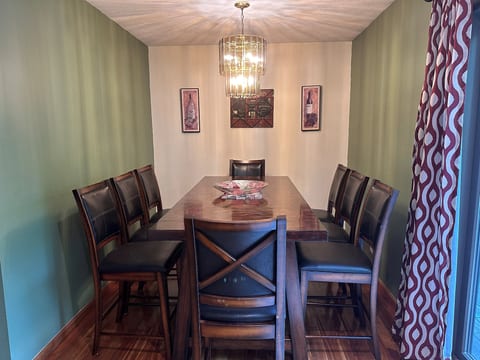 Dining room table with 8 or 10 chairs, plus an additional 4 stools for the peninsula snack bar.