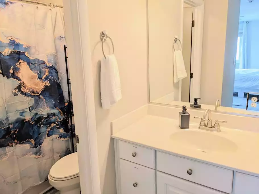 Master en-suite with tub/shower combo. Master en-suite with tub/shower combo. - Exclusive Beachfront Home w/ 180° Views & Hot Tub - Hampton