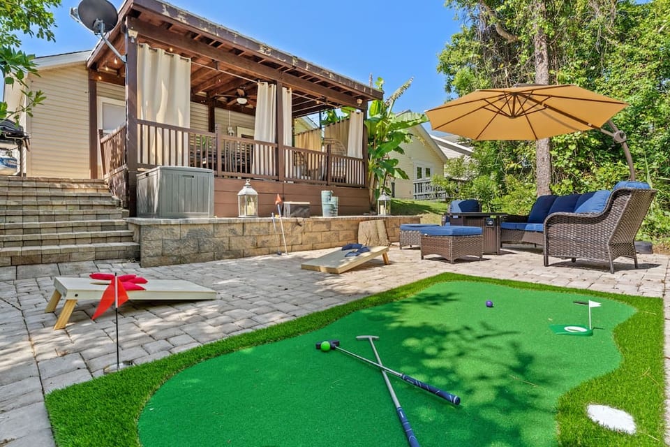 Enjoy your own private, string-lit outdoor space with a putting green, fire pit, covered deck, yard games and more!
Note: the umbrella in this photo is no longer available for use as it has broken.