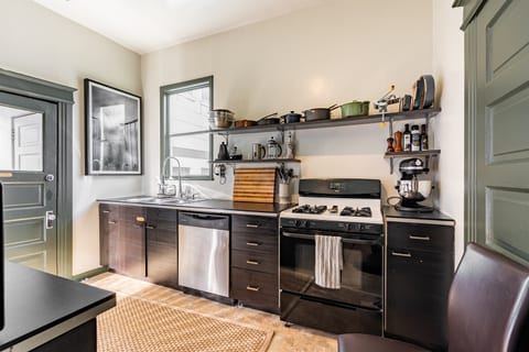 Kitchen leads to shared laundry area