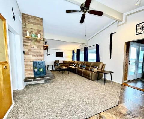 View of living room and upper deck door from hallway from front door entryway