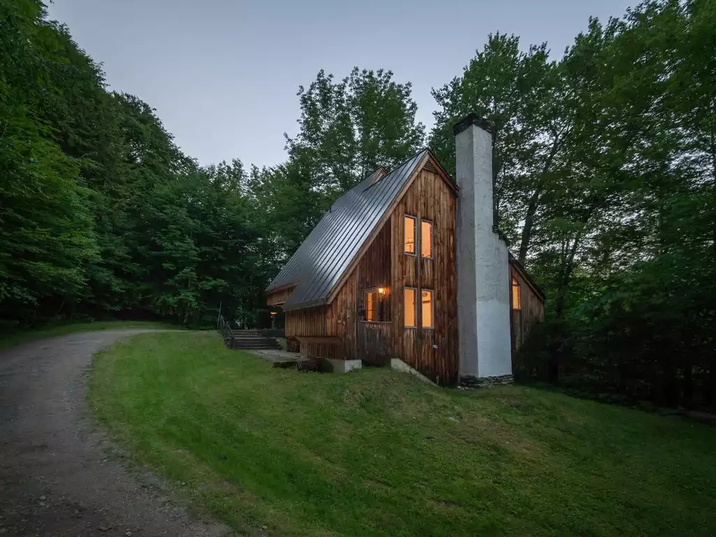 View of the house as you come up the drive at dusk. - The Crooked House - Stockbridge