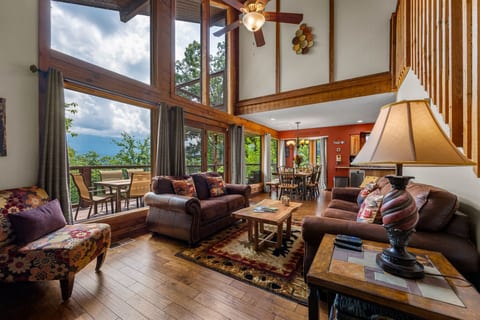 Living room with vaulted ceilings, floor-to-ceiling windows, and direct views of Mount LeConte.