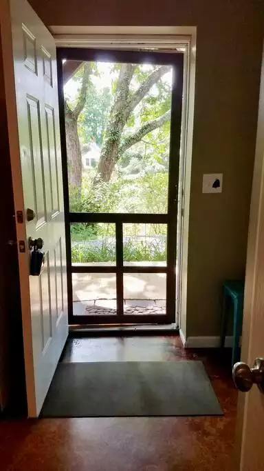 Screen door for fresh air and a view from the apt.