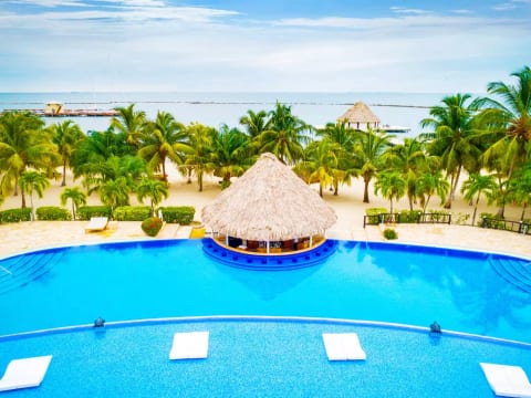 Largest swimming pool in Belize with swim up tiki bar! Best Caribbean Rum Punch around.