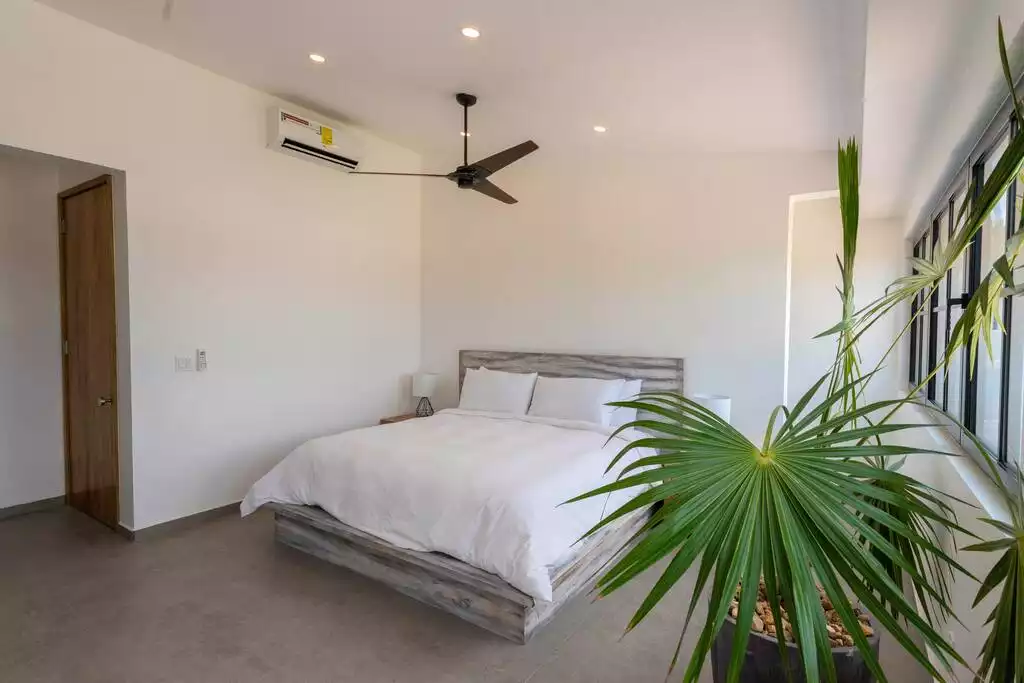 Second upper level bedroom with king bed, en suite bath & walk-in closet Second upper level bedroom with king bed, en suite bath & walk-in closet - Spectacular beachfront home with pool, gym, more! - San Pedro