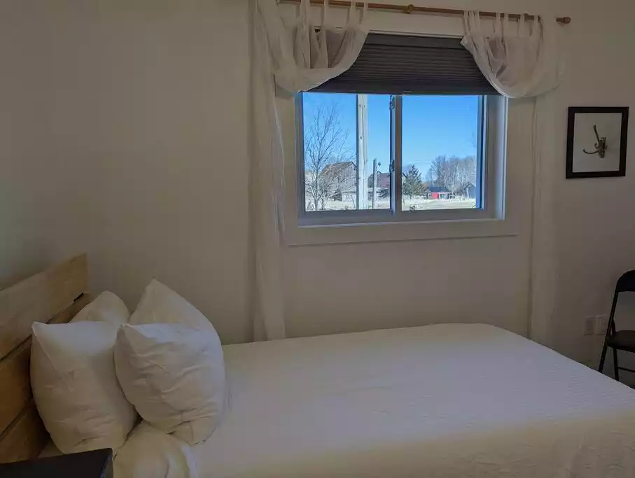 Twin room has black out curtains and overlooks our yard and our neighbours picturesque barns. - Family Friendly Suite with Arcade and Park Pass - Prince Edward