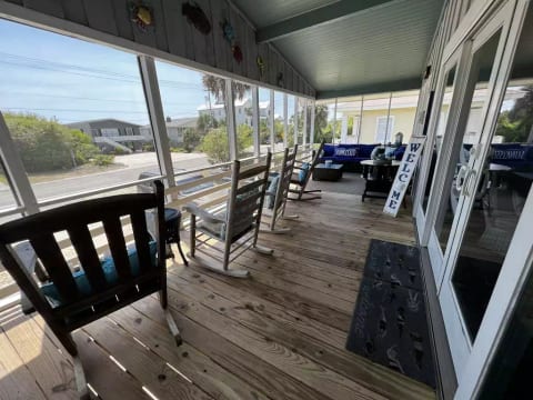 Large screened in rocking chair front porch