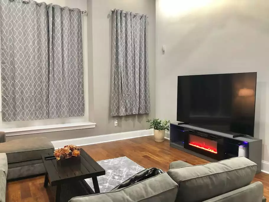 Our Family Room with 85" TV and 20' ceilings is perfect for entertaining