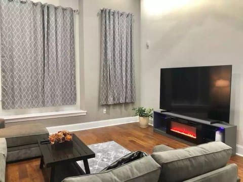 Our Family Room with 85" TV and 20' ceilings is perfect for entertaining