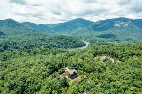 Drone view of house and lake below. The property is not lake front, but we are a 1.5 mile drive from the marina and beach area. 