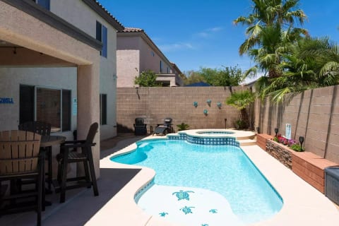 The backyard pool area has plenty of seating for eating, relaxing, sunbathing, or whatever.