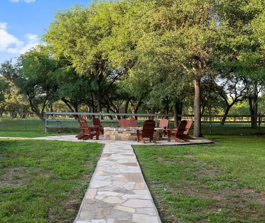 Fire pit steps away from the pool that can seat 10. - Main House at Whispering Oaks Estate - Dripping Springs