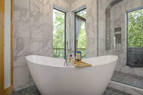 Relax in soaking tub, windows have privacy curtains, not shown for purpose of lighting