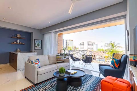 Beautifully furnished open concept space with wide glass doors opening up to the large Balcony.