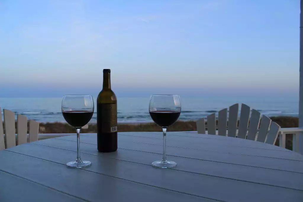 Relax on the ocean front deck after a sunny day at the beach with a glass of your favorite wine - isn't life at the beach great? Relax on the ocean front deck after a sunny day at the beach with a glass of your favorite wine - isn't life at the beach great? - Pearl by the Sea - North Topsail Beach
