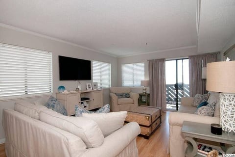 living room looking toward balcony and ocean