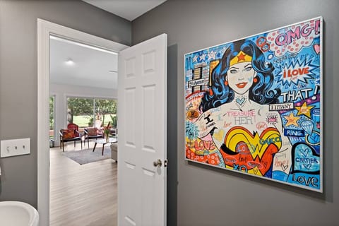 The powder room is located off the living room. Superhero included.