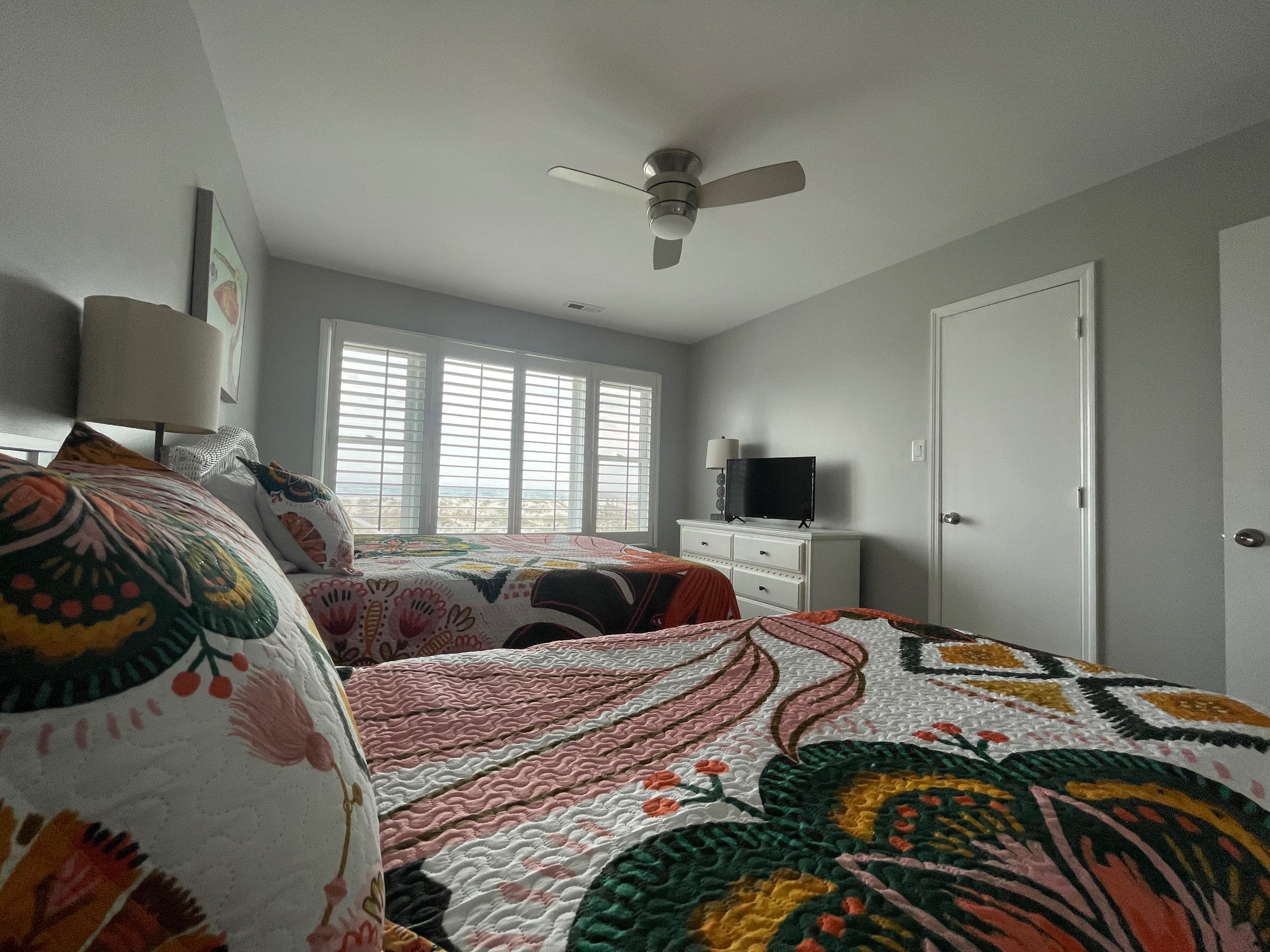 Large oceanfront bedroom with queen and twin beds West