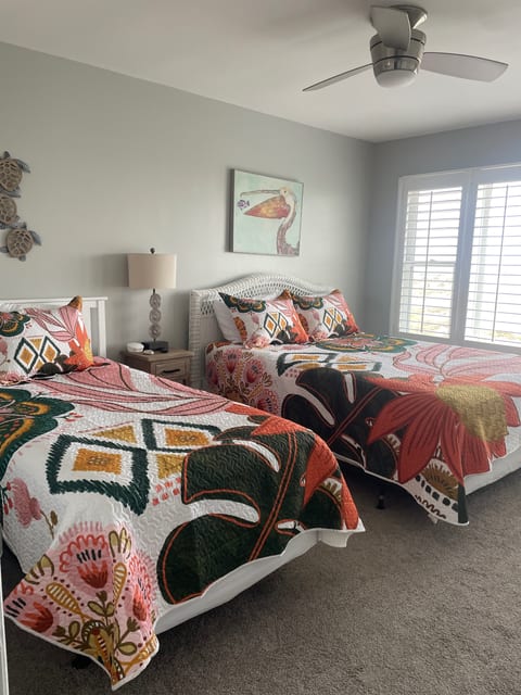 Large oceanfront bedroom with queen and twin beds West