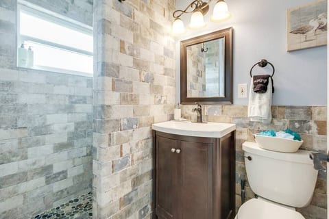 The stylish bathroom features a walk-in rainfall shower.