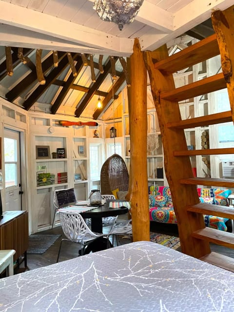 Looking at the living area and ladder to the loft, from the treehouse bed.