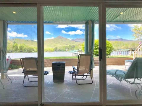 One of the many picture windows in the suite. This is your patio with a gas fire pit. There is also a wood-burning firepit on the lawn.
