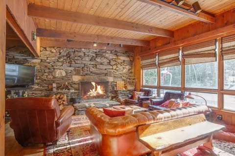 Living room with large handmade Chesterfield leather sofa, two vintage leather club chairs and vintage leather recliner chair is perfect for snuggling up in front of fire with a good book, or binging on a new Netflix series.