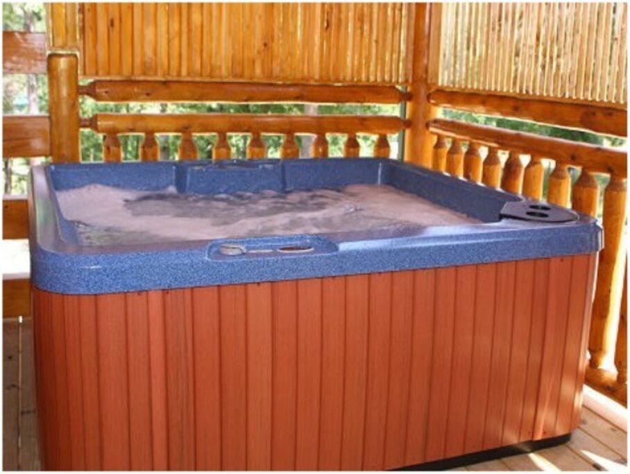 The Back Porch has a Bubbling Hot Tub with Two Rocking Chairs