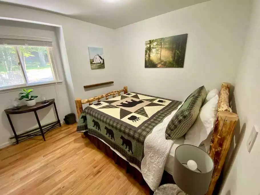 Guest bedroom with queen size log bed, bedstead charging station, and full sized closet. - Escape to a 3-Bedroom Cabin in Lower Catskills - Woodridge