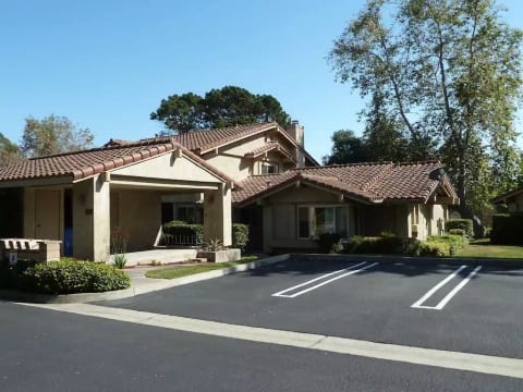 Carport or open parking at front door- single level end unit