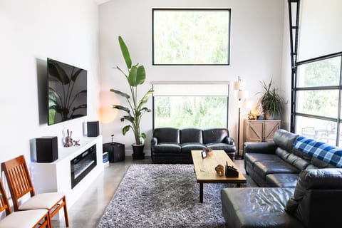 1st floor living room provides Klipsch reference stereo speakers paired with a Klipsch subwoofer for boomy music - they're connected to the TV but can also be paired to a bluetooth device. 2 leather couches, 75" TV, electric fireplace, garage door!