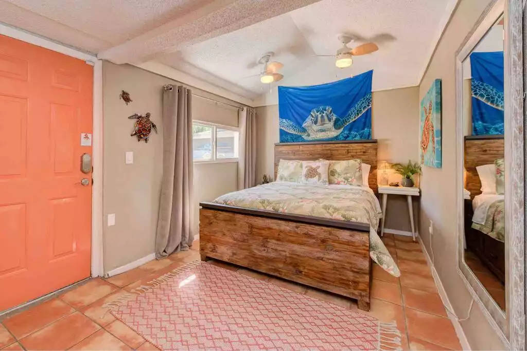 Turtle Cove – 
Tucked in the back of the house and has a private hallway. 
Queen size, very comfy mattress and pillows to sink your head into.  Drawers under the bed, closet with lots of hangers, luggage rack and a comfy robe. - Copacabana - Lubbock, TX with an Island Flair! - Lubbock