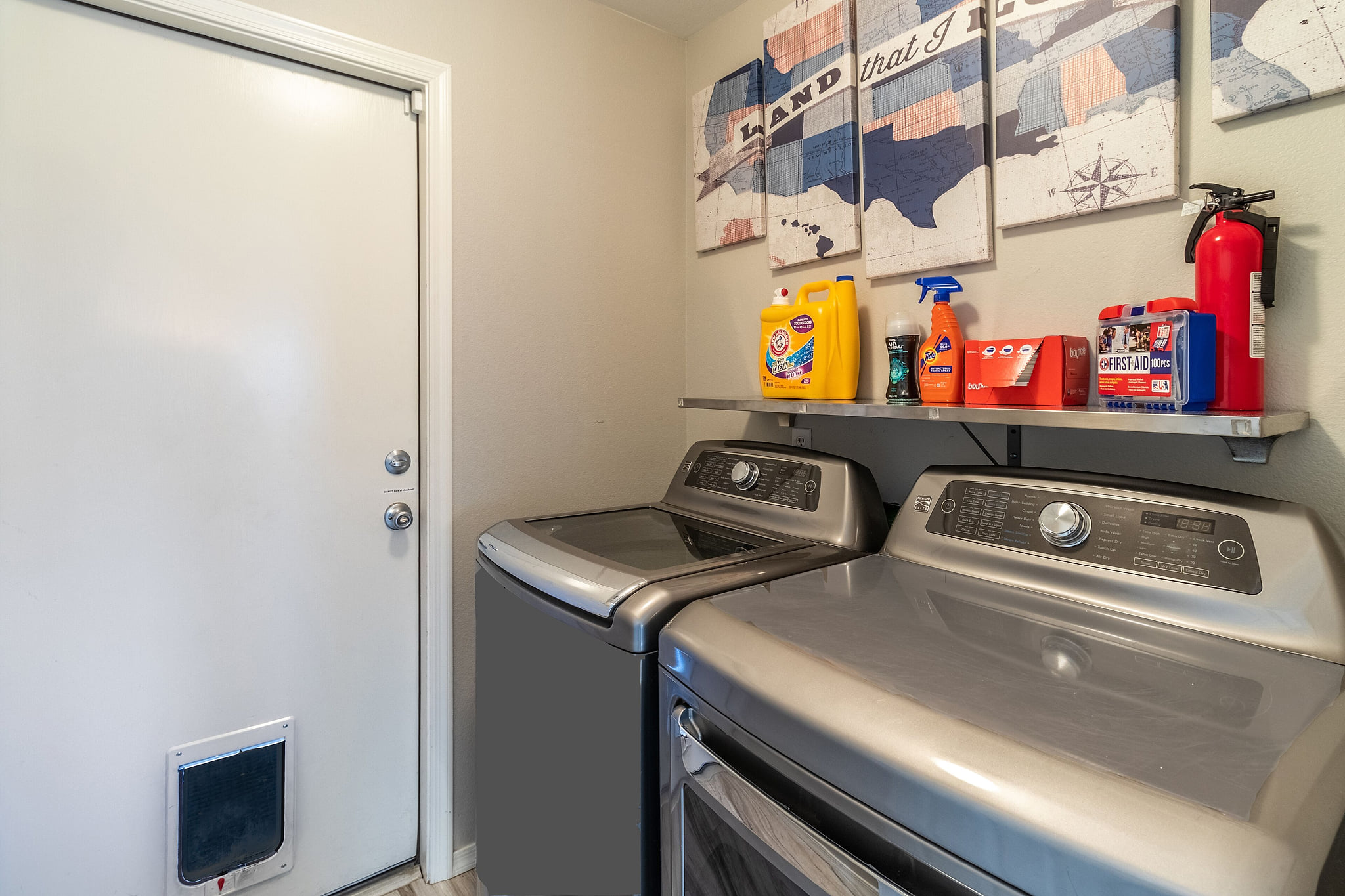 Full size washer and dryer with soaps and dryer sheets.