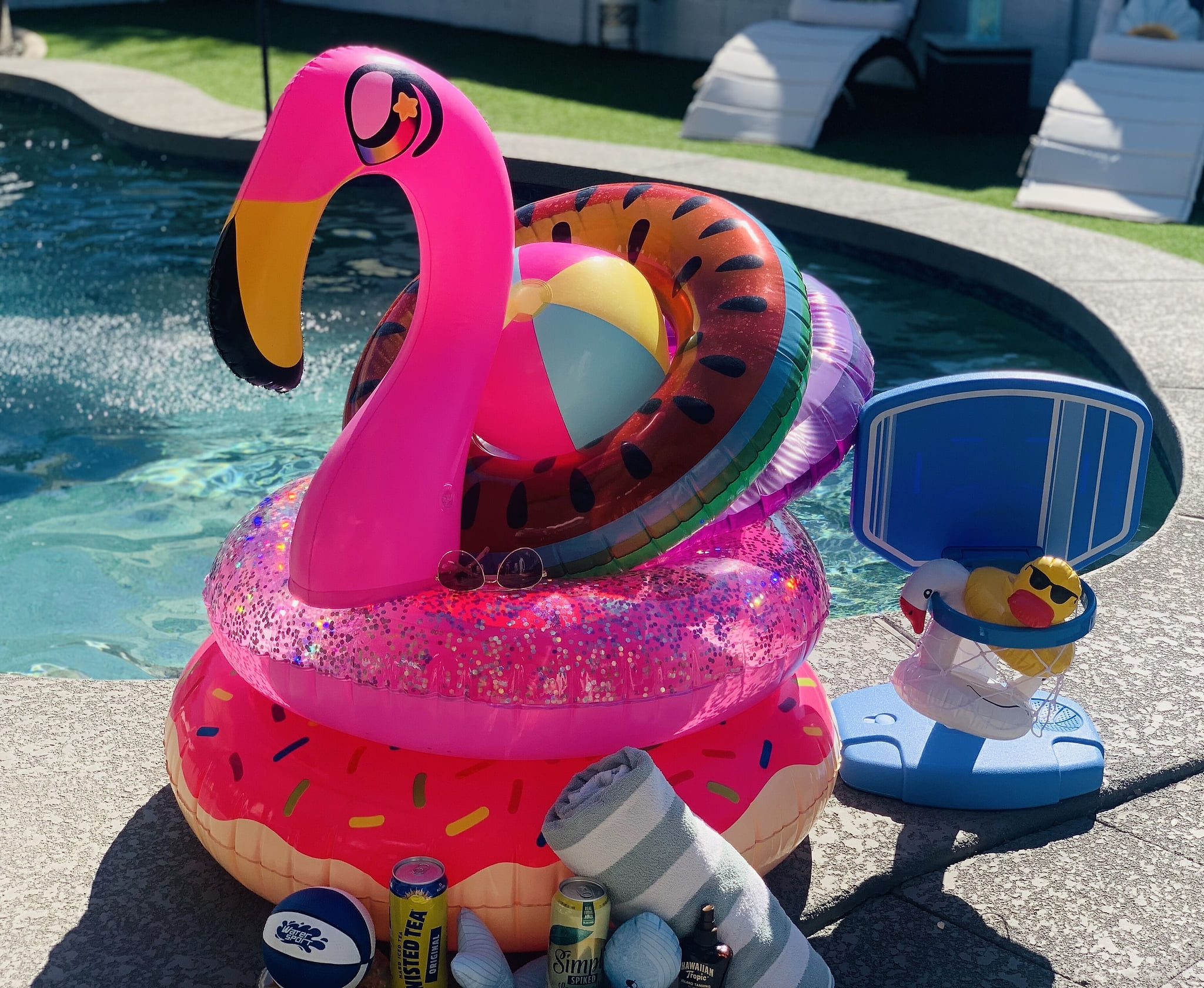 Lots of pool floats, volleyball net, and various pool toys provided.