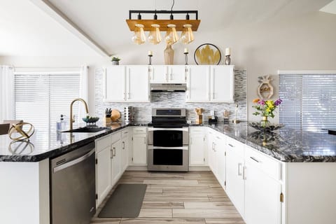 Fully stocked remodeled stylish kitchen with granite counter tops brass accents and new light fixtures. Kenmore Elite Double oven, full size refrigerator, ice maker, dishwasher & garbage disposal.