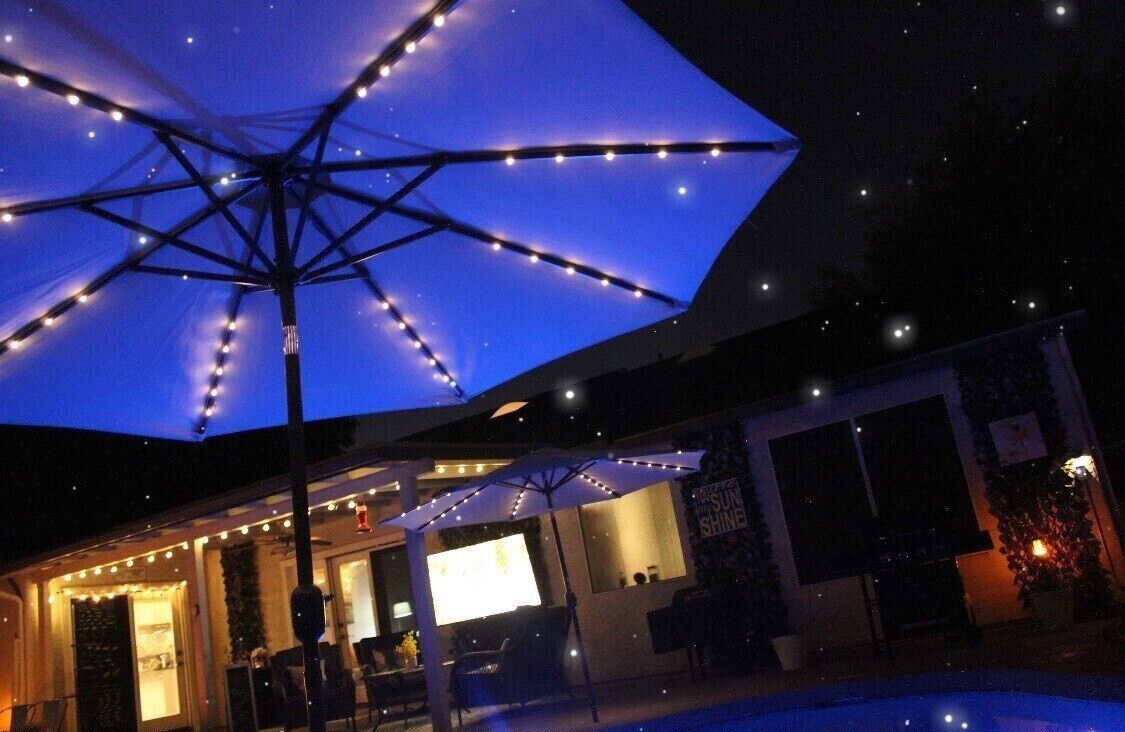The backyard sparkles at night with lights and a led color changing pool light