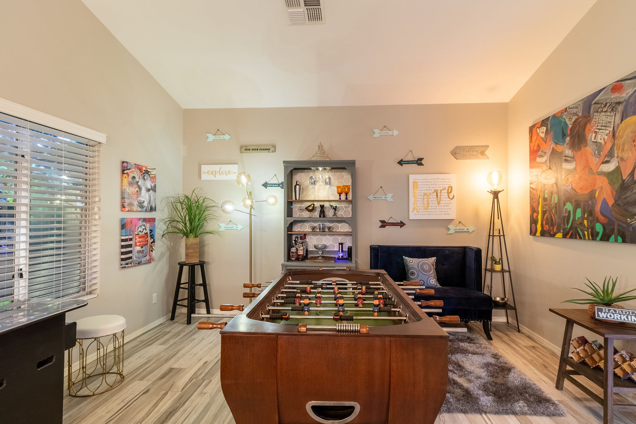 Game room with Foosball, arcade game and bar area.