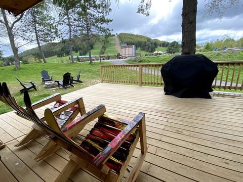 Gorgeous views of Wisp Mountain from the oversized deck at Slippery Slope Cabin.  On the deck you will find a hot tub, rocking chairs, picnic table not pictured) and propane grill.  The fire pit is ju