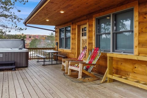 Grab something to drink and relax on in the hot tub or in the rocking chairs of this amazing cabin!