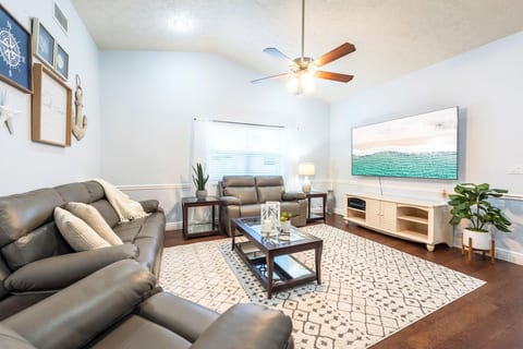 Relax and watch a movie or a show on the 82" SmartTV with Leather Sofas with recliners.