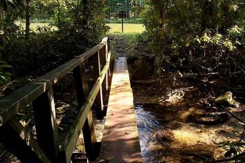 Steel beam bridge to the pond.