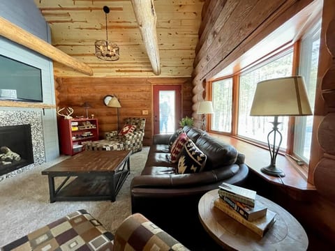 custom leather furniture, new decor with custom gas fireplace, big screened TV and vaulted space, accessible to decks and screened porch.