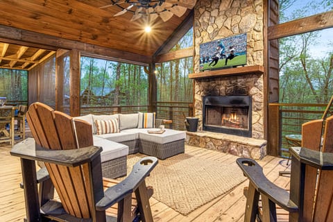 Gather around for the ultimate outdoor experience! Enjoy the warmth of the stone fireplace, watch your favorite game on the big screen, a rocking swing, and take in the serene forest views from the comfort of our spacious screened-in porch. Perfect for coz