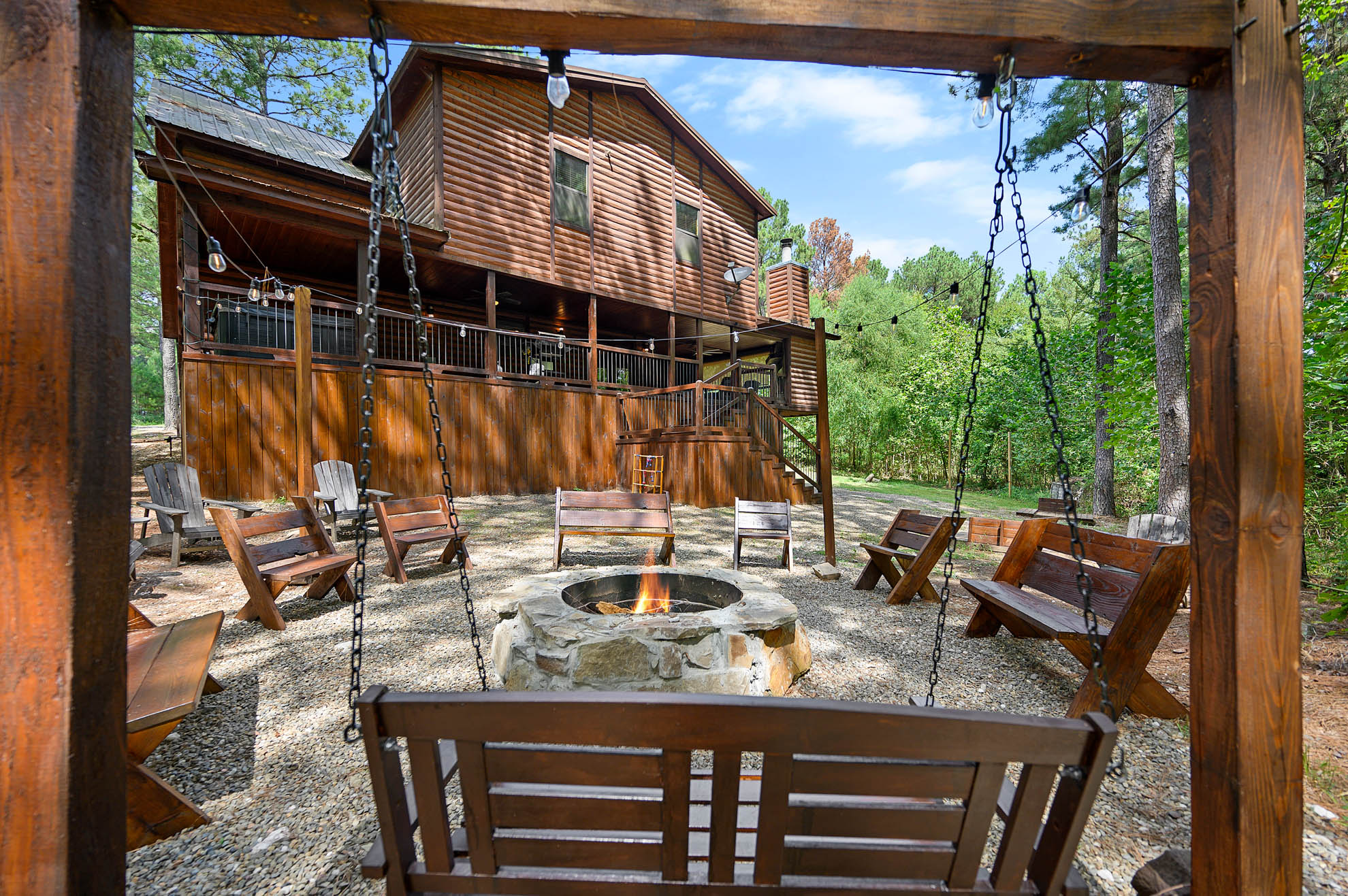 The swing and fire pit has plenty of seating for everyone The swing and fire pit has plenty of seating for everyone - Iron Horse Lodge - Broken Bow