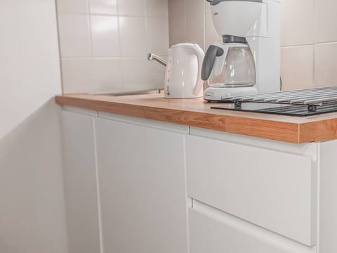 The fridge is smartly integrated behind the middle cabinet door.
There's coffee & breakfast supplies in the cabinets. All silverware is of course included.