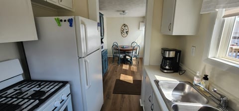 Kitchen and Dining Room
Gas Stove, Refrigerator, Coffee Pot, Microwave.