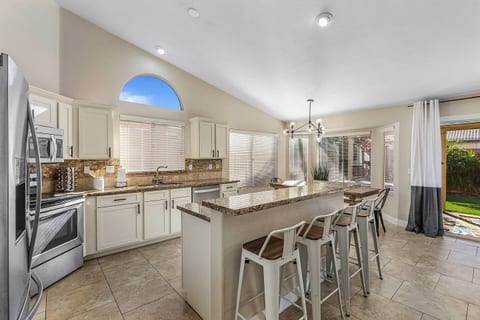 Convenient bar with an additional seating for four people. Kitchen table seats 8. 