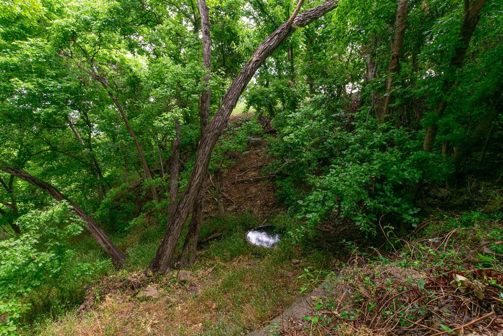 Looking down at the cistern filled by the natural spring. - Spacious 3/2 with Historic Charm & Modern Comfort - Gatesville